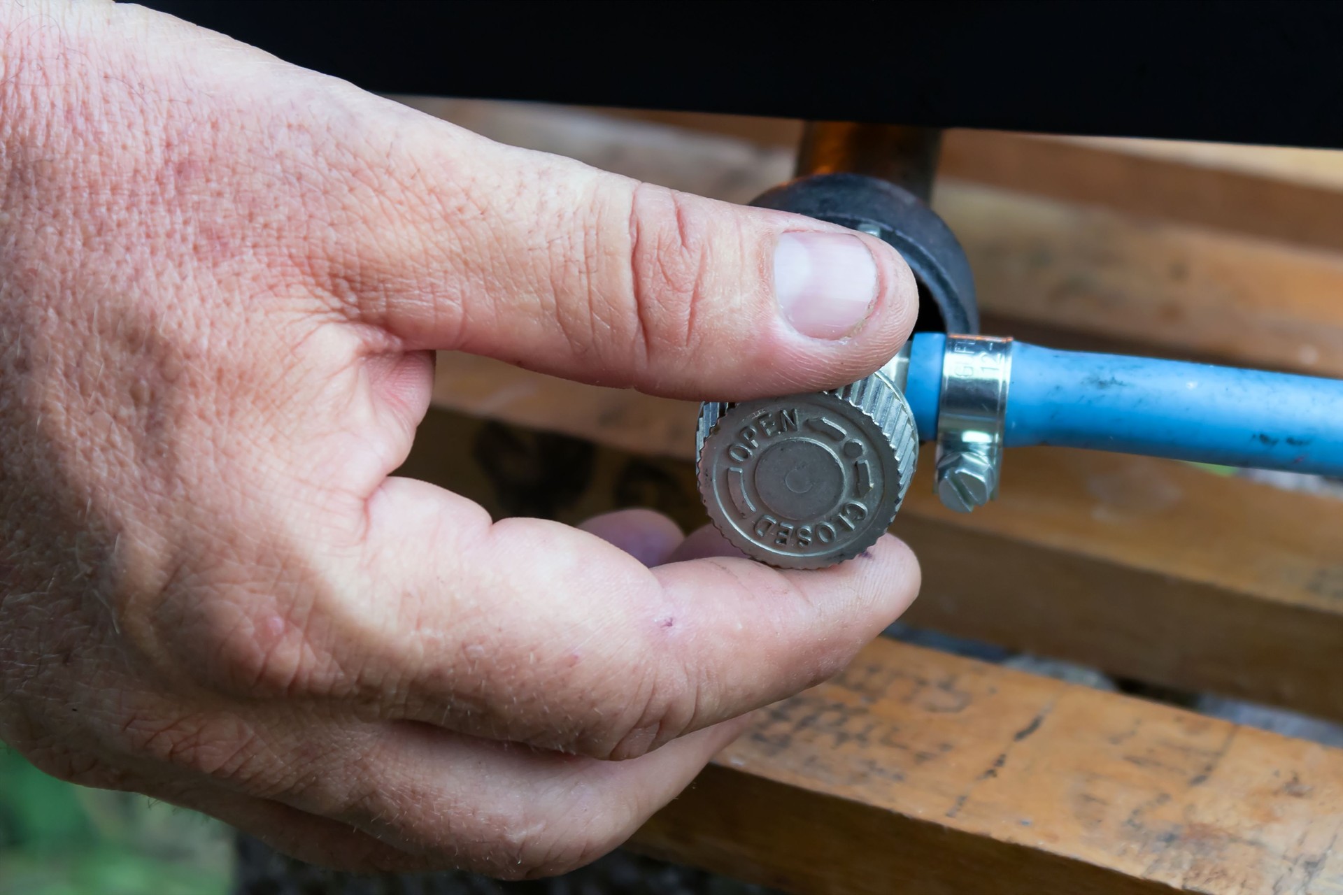 man's hand operating valve